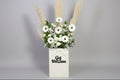 Floral arrangement in a 'Get Well Soon' box on a gray background