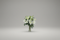 Bouquet of white flowers in a clear vase on a gray background