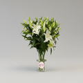 Bouquet of white lilies in a clear vase on a light gray background